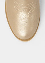 Load image into Gallery viewer, Close-up of a gold shoe sole with embossed design on a white background
